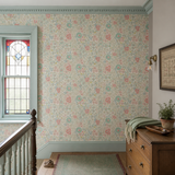 Blue floral wallpaper in a landing, Flora Coral & Sky by OHPOPSI, with joinery painted in Red Clover