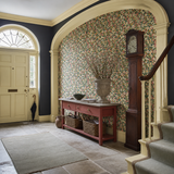 Green floral wallpaper in a hallway, Flora Ditsy Juniper & Ginger by OHPOPSI, with joinery painted in Red Clover