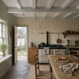Yellow floral wallpaper in a kitchen, Hummingbird - Straw by OHPOPSI, with joinery painted in Strangely Brown