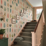 Green botanical wallpaper in a stairwell, Leaf Boogie Tropical Mix by OHPOPSI, with joinery painted in Green Envy