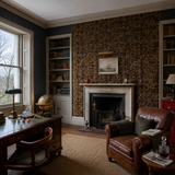 Grey floral wallpaper in a library, Milana Black & Gold by Olenka, with joinery painted in Poppy