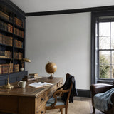 Home office painted in Pebbles architectural grey eco paint, with the fitted bookshelves in Blueberry Tart