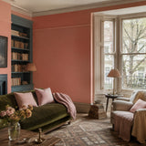 Living room painted in Terrapotta terracotta pink eco paint, with the alcove bookcase in Mermaid's Tail