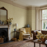 Green floral wallpaper in a sitting room, Tiny Tulip Apple by OHPOPSI, with joinery painted in Meadow Lilly