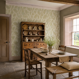 Green geometric wallpaper in a dining room, Twisted Geo Moss by OHPOPSI, with joinery painted in Strangely Brown