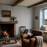 Blue botanical wallpaper in a snug, Venation Mini Denim by OHPOPSI, with joinery painted in Atlantic Ocean